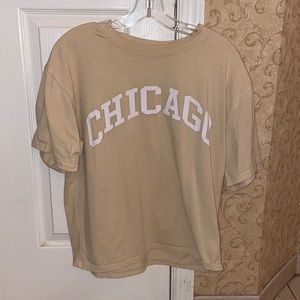 Yellow tee shirt with the word “CHICAGO” on it